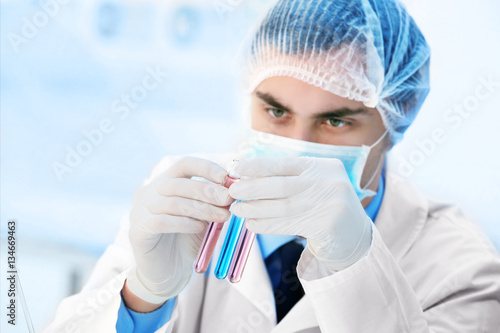 Young male scientist making...