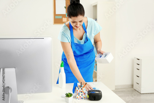 Young woman cleaning comput...