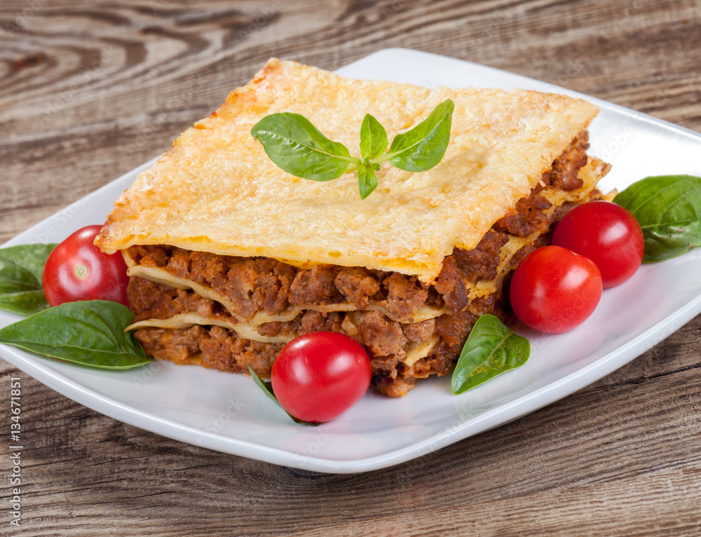 tasty lasagna isolated on the old board tasty lasagna isolated on the old board