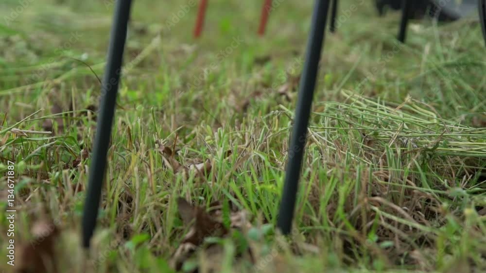 We can see rotary rakes slowly moving on the grass. A farmer is starting to prepare hay on a big grass field.
We can see rotary rakes slowly moving on the grass. A farmer is starting to prepare hay on a big grass field.