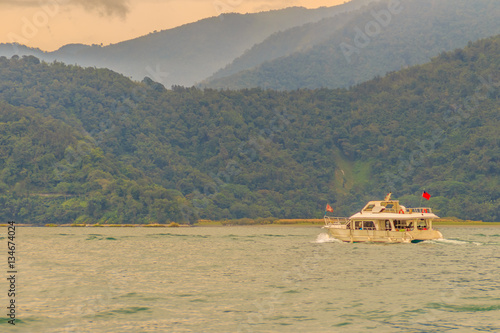 Tourist likes to visit the beautiful attractions around the sun moon lake by boat cruise from Shuishe Pier to Ita Thao Pier, and then to Xuanguang Temple Pier photo