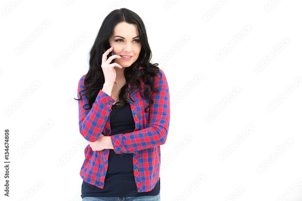 Girl in checkered shirt speaking on cellphone. Girl in checkered shirt speaking on cellphone.