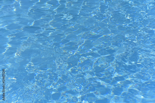 Blue and bright ripple water and surface in swimming pool 