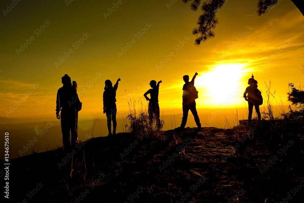 group of people, Happy hiking standing on a cliff side with arms raised up