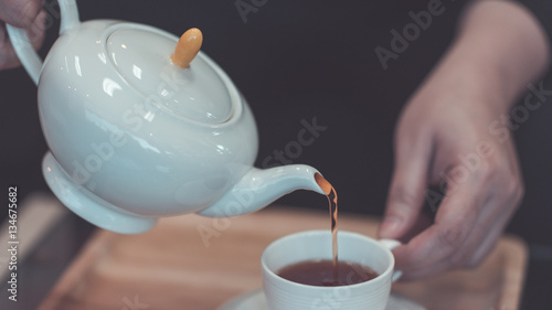 Hand holding a teapot