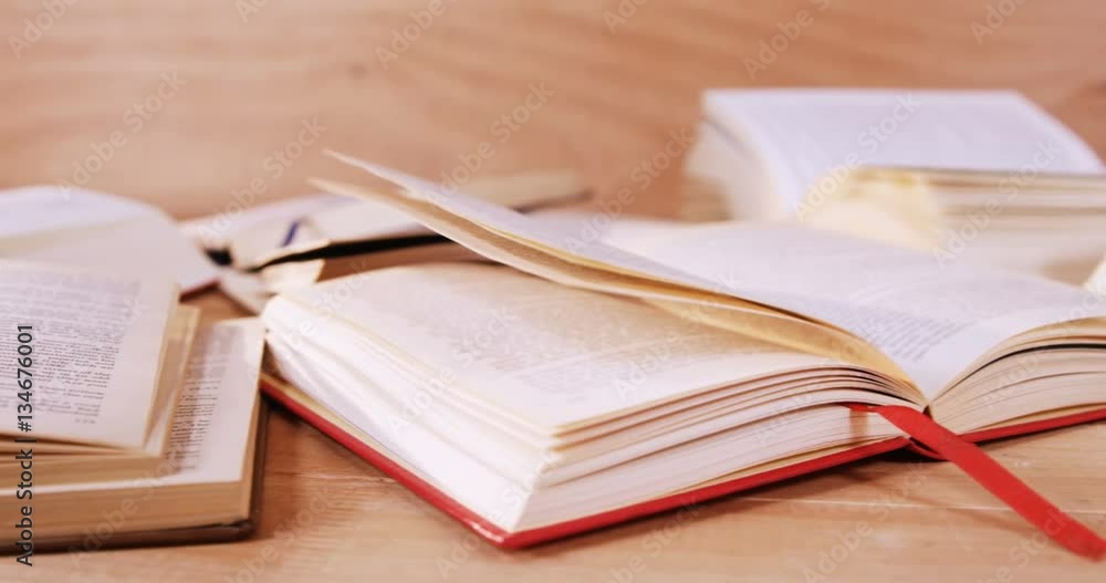 Close-up of various open book on desk 4k Close-up of various open book on desk 4k