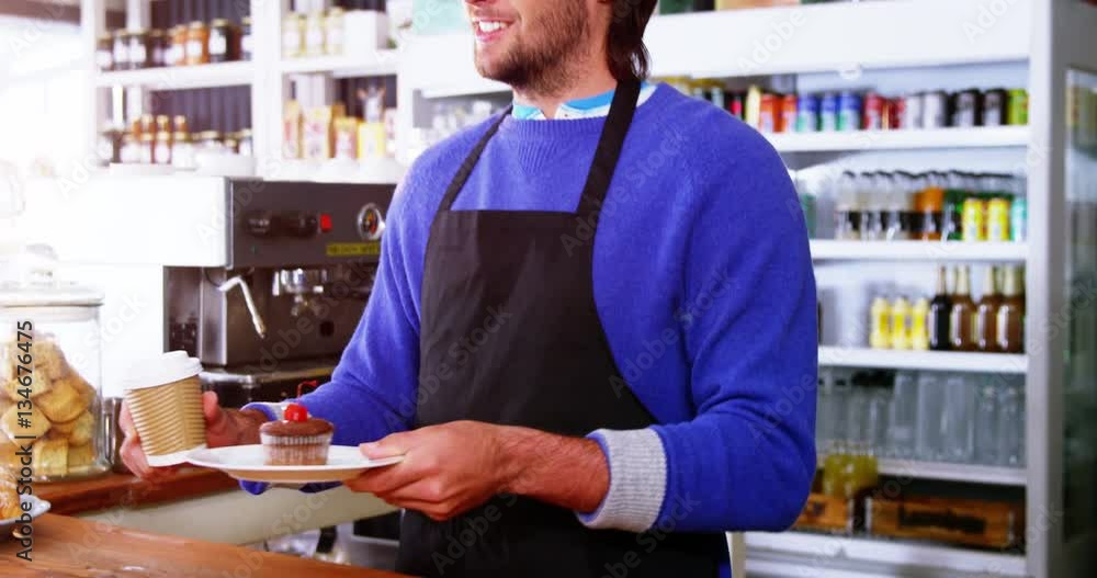 Waiter serving coffee and cupcake to customer at counter in café 4k Waiter serving coffee and cupcake to customer at counter in café 4k