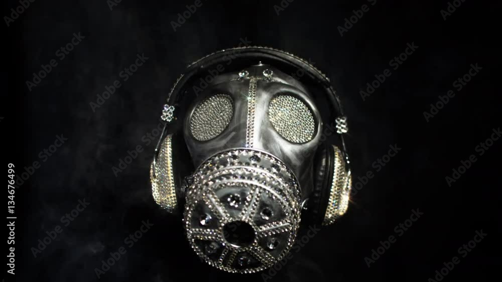 a gas mask covered in sparkling crystals spins on a mannequin head. this is a special handmade item from our studio. how to survive the apocalypse in bling bling style a gas mask covered in sparkling crystals spins on a mannequin head. this is a special handmade item from our studio. how to survive the apocalypse in bling bling style