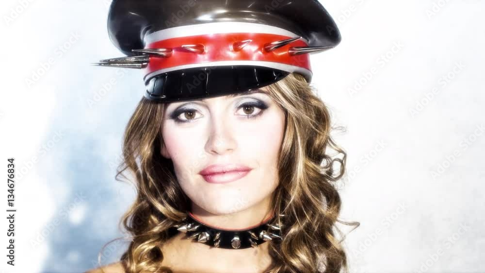 sexy beautiful woman posing and looking around wearing a spiked latex military hat sexy beautiful woman posing and looking around wearing a spiked latex military hat