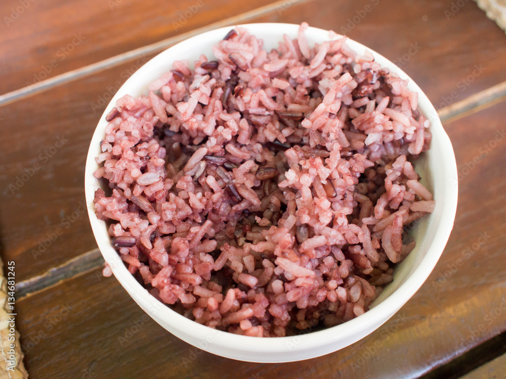 Coarse rice in a white bowl on wooden background. Coarse rice in a white bowl on wooden background.