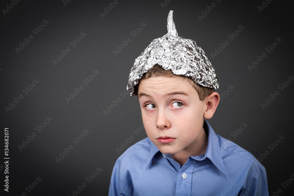 Boy in a tin foil hat looking up StockFoto Adobe Stock