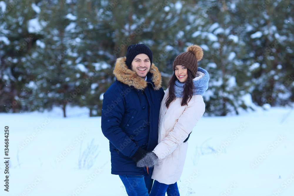 Love couple walking in winter forest Love couple walking in winter forest