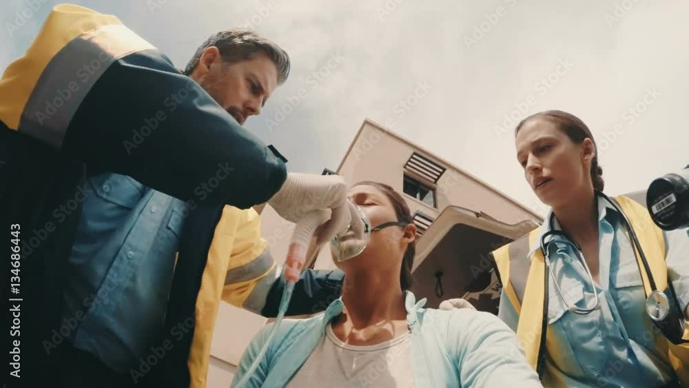 Doctor putting an oxygen mask on patient