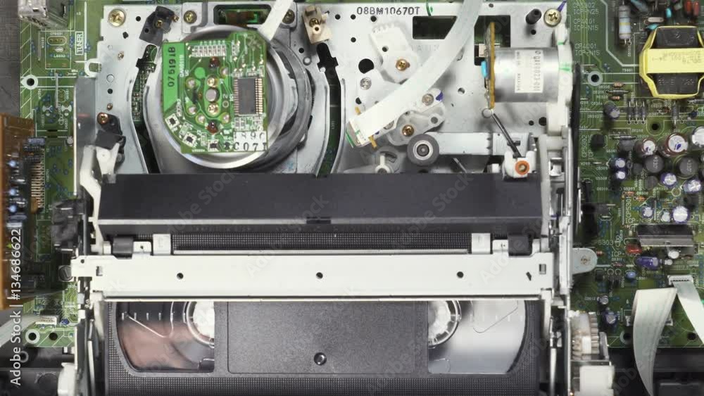 VHS, video player loads and reads the tape, the process of working vhs player, close-up. 4k footage. Camera movement. VHS, video player loads and reads the tape, the process of working vhs player, close-up. 4k footage. Camera movement.