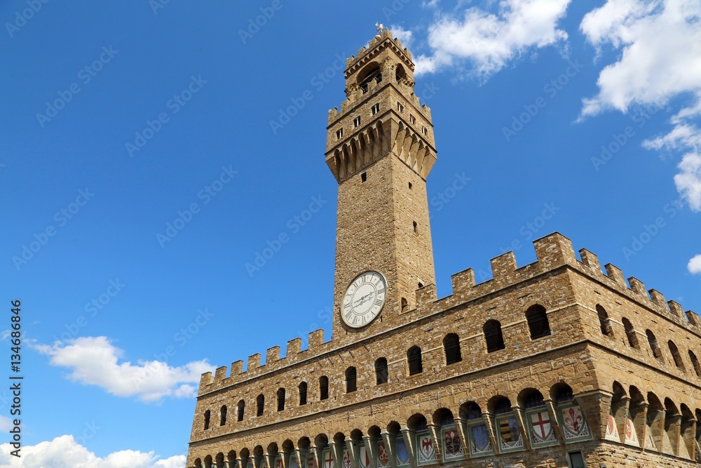 FLORENCE Old Palace and clock tower with blue sky in Signoria sq