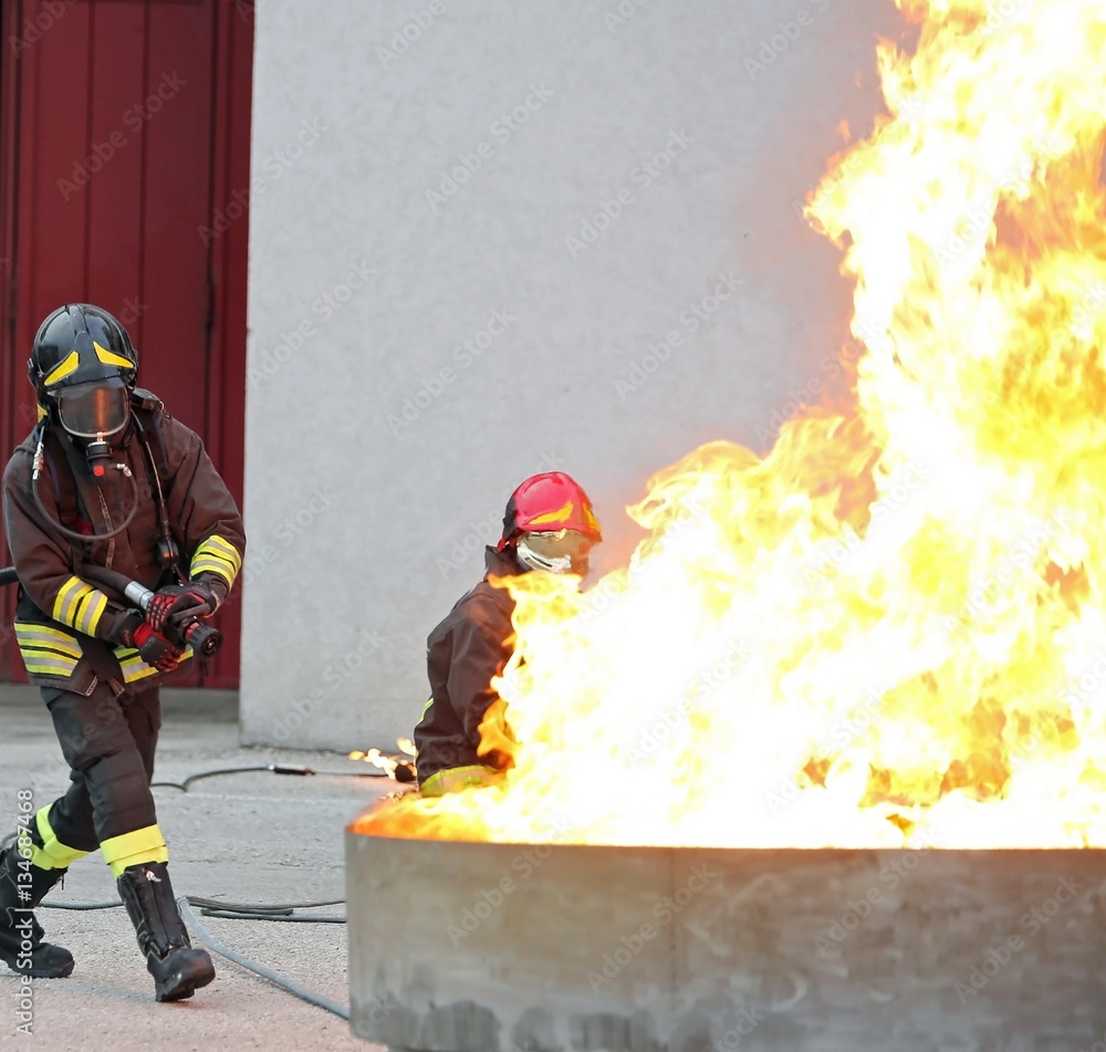 Fototapeta premium Firefighters during a training exercise off a huge fire 