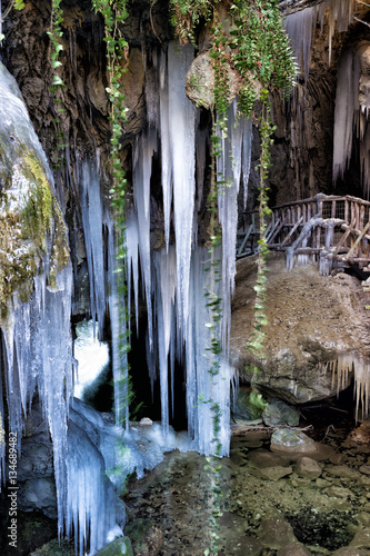 View of stalactites and stalagmites of ice at the entrance of a cave
