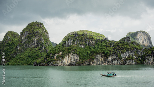 Ha Long Bay, Vietnam - December 02, 2015: Cruise boat near rock islands in Halong Bay, Vietnam, Southeast Asia
