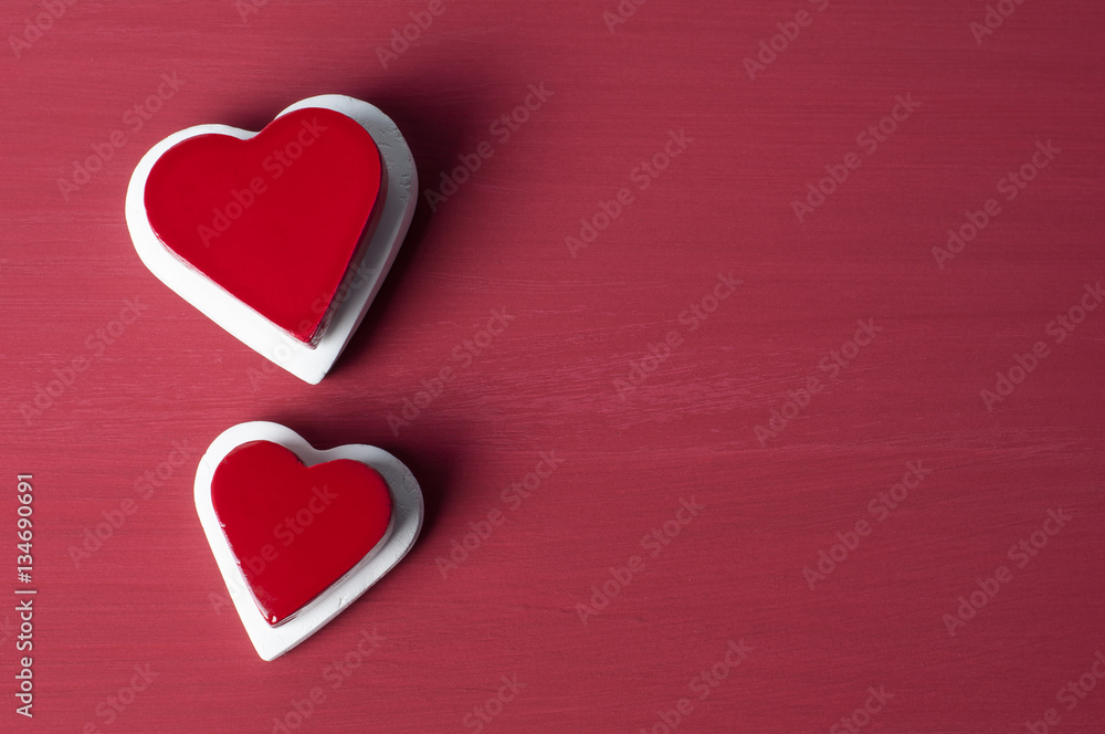 Double red heart on white heart on red grunge background.