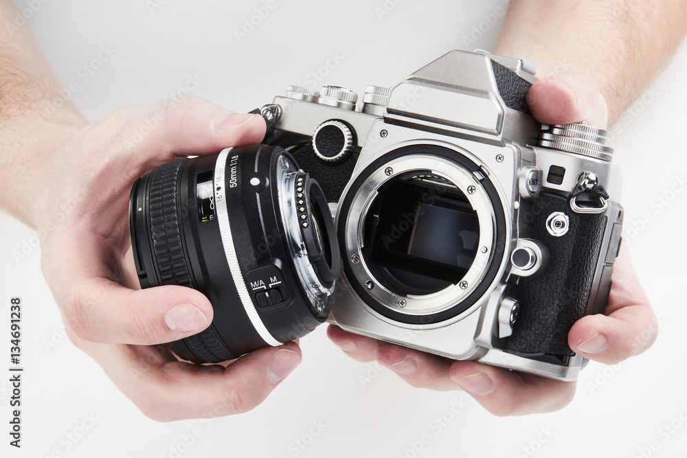Retro photo SLR camera in hands of photographer closeup
