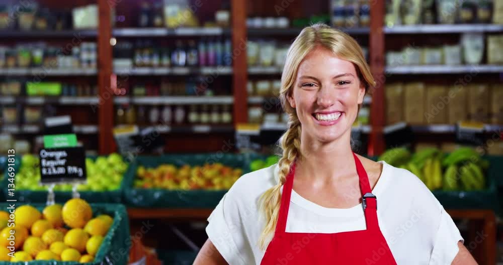 Portrait of smiling female staff standing with hands on hip in grocery section of supermarket 4k Portrait of smiling female staff standing with hands on hip in grocery section of supermarket 4k