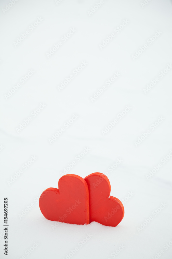 Red heart in the snow on a winter background. St. Valentine's Day Red heart in the snow on a winter background. St. Valentine's Day