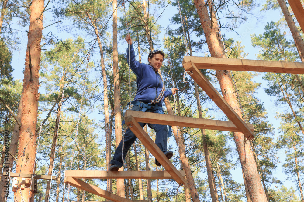 Gomel, Belarus - OCTOBER 5, 2014: Rope town for a family holiday in the countryside. Family competition to overcome aerial obstacles. Gomel, Belarus - OCTOBER 5, 2014: Rope town for a family holiday in the countryside. Family competition to overcome aerial obstacles.