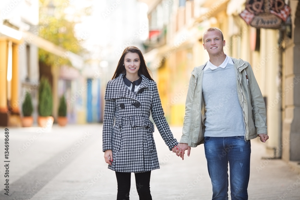 Couple in love walking outdoors and holding hands