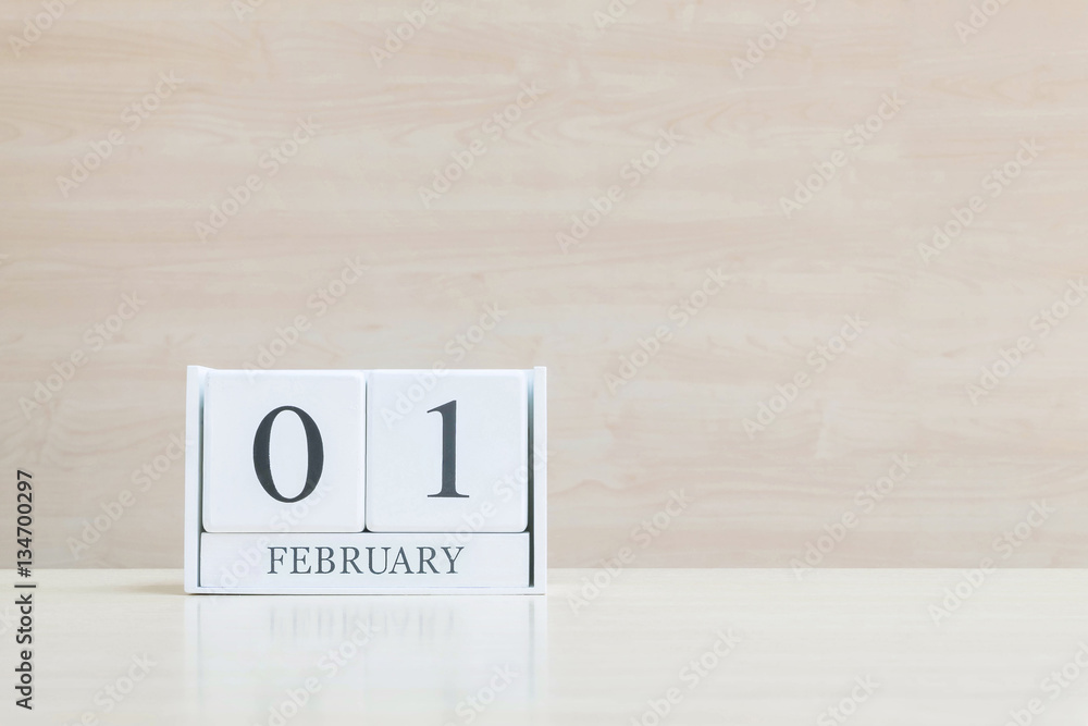 Closeup surface white wooden calendar with black 1 february word Closeup surface white wooden calendar with black 1 february word