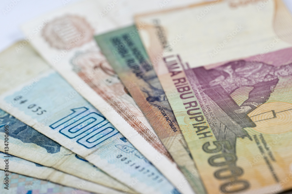 Close up view from indonesian rupiah banknotes and argelian banknotes. Close up view from indonesian rupiah banknotes and argelian banknotes.