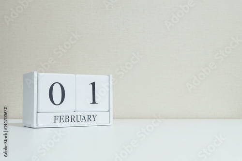 Closeup white wooden calendar with black 1 february word on blur