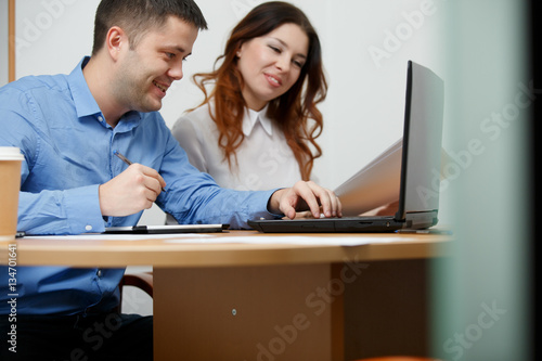 Office staff sitting at table