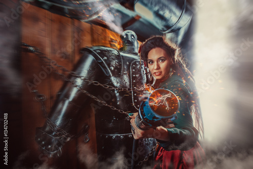 A beautiful woman with the connector of burning male robot. © diter