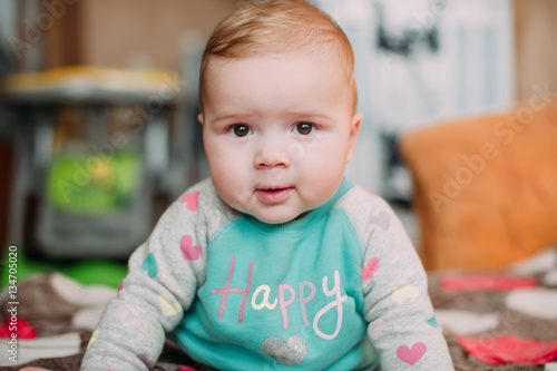 little cute baby toddler on carpet close up smiling adorable happy emotional playing at home