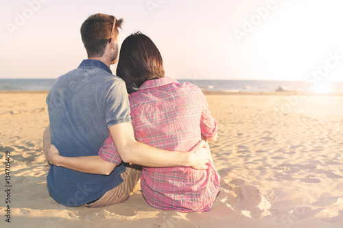 couple in love imagines the future looking at the sunset
