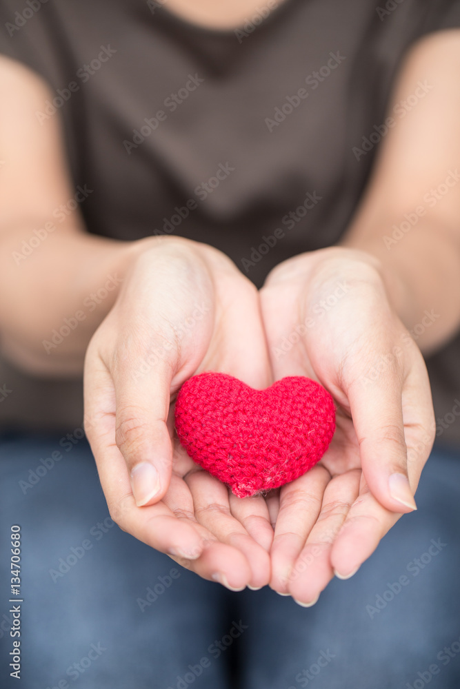 giving love. red heart in women her hand giving love. red heart in women her hand