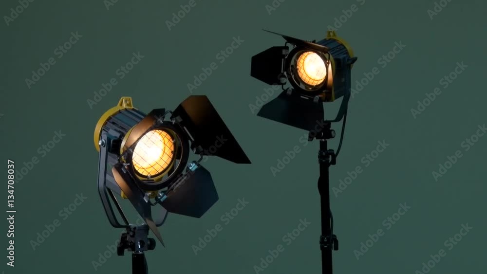 Two lights with Fresnel lenses. Halogen lamp. Activation of the device. Power adjustable with dimmer switch. Off. Photography, videography, filming, shooting. Two lights with Fresnel lenses. Halogen lamp. Activation of the device. Power adjustable with dimmer switch. Off. Photography, videography, filming, shooting.
