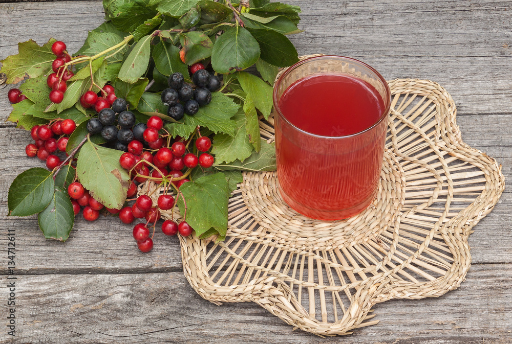 Drink of the viburnum and aronia on a wooden background Drink of the viburnum and aronia on a wooden background