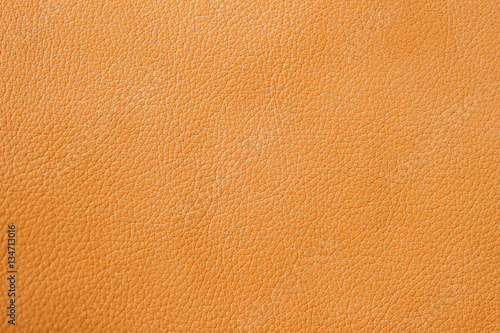 Texture of genuine leather close-up, cowhide, orange, for background , backdrop, substrate use. © svetlanais