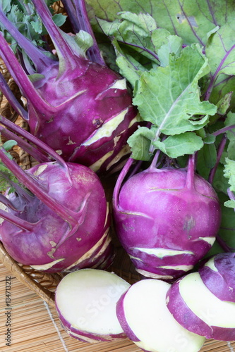 Purple kohlrabi cabbage with green leaves