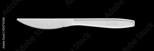 White plastic Knife isolated on black background photo