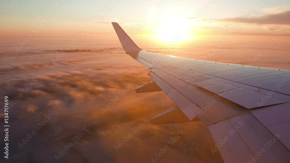 Aerial view of sunrise through airliner window
Aerial view of sunrise through airliner window
