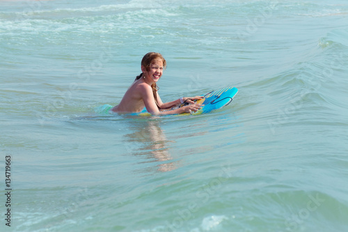 Bodysurfing - young girl surfing in the Mediterranean Sea, Spain