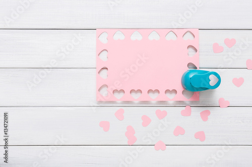 Valentine day card, craft scrapbooking background, hole punch heart form photo