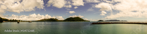 Wallpaper Mural Large panorama of a tropical island taken from a port with a jetty made of stones, Praslin Island, Seychelles Torontodigital.ca