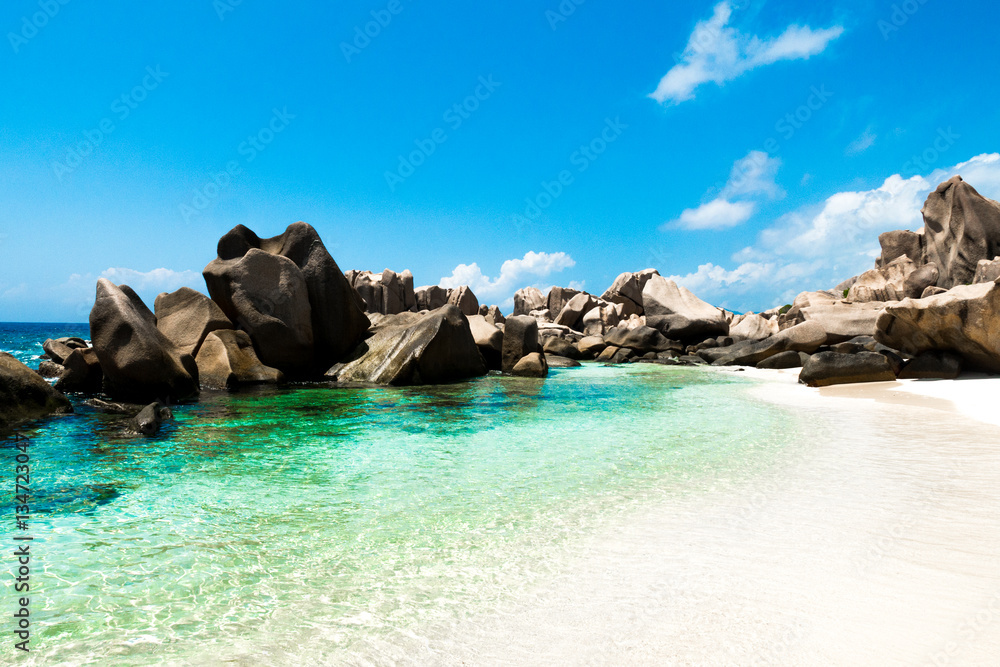 Fototapeta premium Natural pool on a tropical beach with huge rocks , Anse Marron, La digue, Seychelles