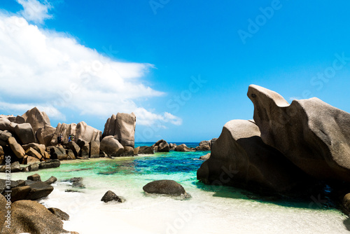 Natural pool on a tropical beach with huge rocks , Anse Marron, La digue, Seychelles