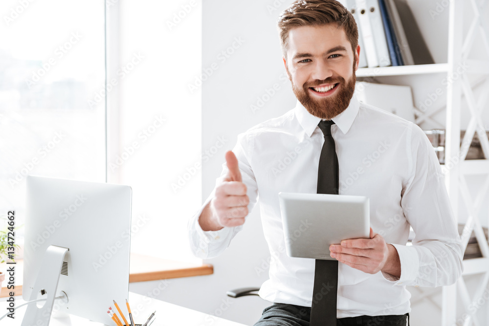 Businessman holding tablet and make thumbs up gesture. Businessman holding tablet and make thumbs up gesture.