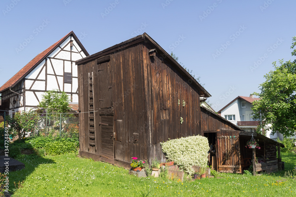 Alte Scheune auf einer Wiese vor einem Fachwerkhaus Alte Scheune auf einer Wiese vor einem Fachwerkhaus