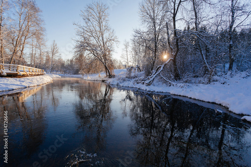 Winter park with snow trail and river at sun day © Eduard Panichev